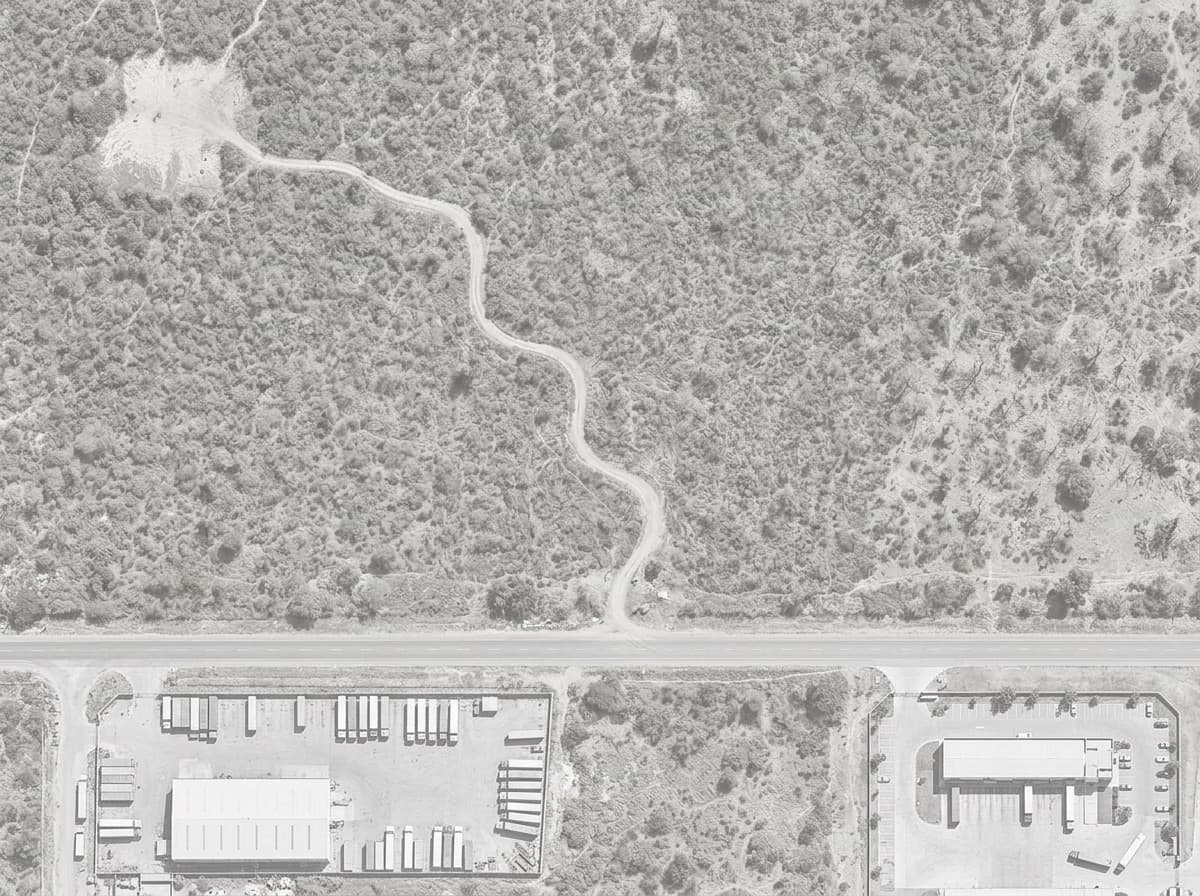 Aerial view of a logistics area: the depot, the client site and, further away, a vacant lot.